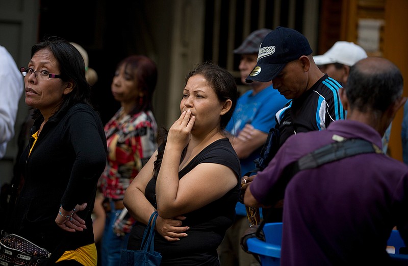 
              People wait in a line outside a supermarket in Caracas, Venezuela, to buy price regulated toilet paper made available for sale by the government, Friday, Jan. 22, 2016. In a note published Friday, the International Monetary Fund Western Hemisphere Director Alejandro Werner said inflation would more than double in the economically struggling South American country in 2016, reaching 720 percent. (AP Photo/Fernando Llano)
            