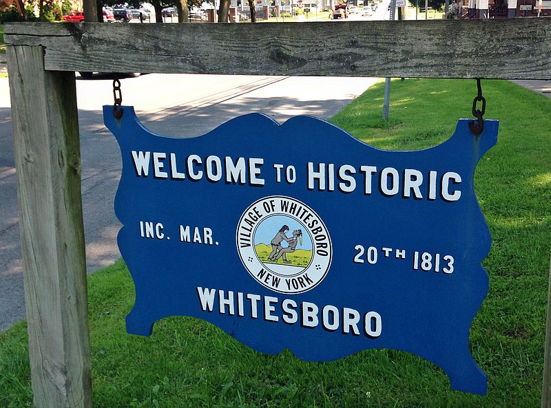 In this photo taken July 16, 2015, a welcome sign on the village green, Whitesboro, N.Y., displays the village seal. Whitesboro will let voters decide whether to keep the longtime village seal that has been called offensive to Native Americans.