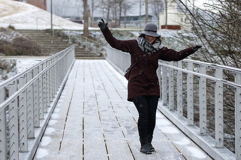 Rina Handwerker slides on an icy bridge in Renaissance Park after winter storm Jonas swept across the Eastern United States on Saturday, January 23, 2016, in Chattanooga, Tenn. While much of the East Coast received heavy snowfall, the Tennessee Valley was less affected.