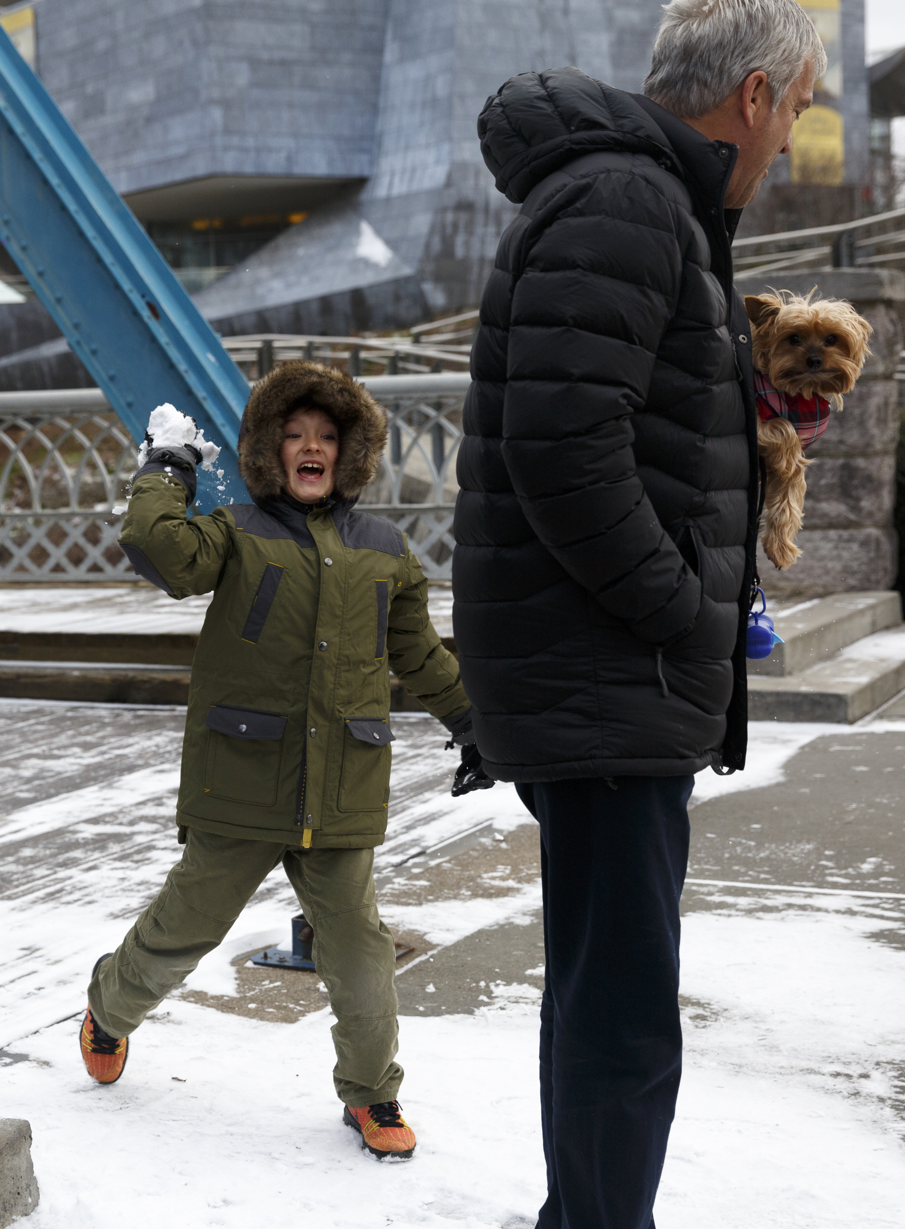 Davis Bartow throws a snowball at his father Doug near the Walnut Street Bridge after winter storm Jonas swept across the Eastern United States on Saturday, January 23, 2016, in Chattanooga, Tenn. While much of the East Coast received heavy snowfall, the Tennessee Valley was less effected.