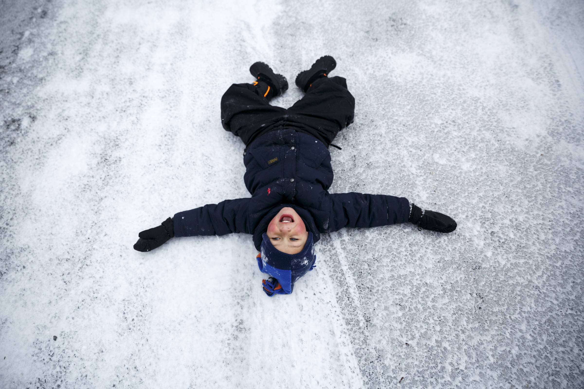 Gus Covert slides on icy pavement near the Signal Mountain Town Hall after winter storm Jonas swept across the Eastern United States on Saturday, January 23, 2016, in Signal Mountain, Tenn. While much of the East Coast received heavy snowfall, the Tennessee Valley was less effected.
