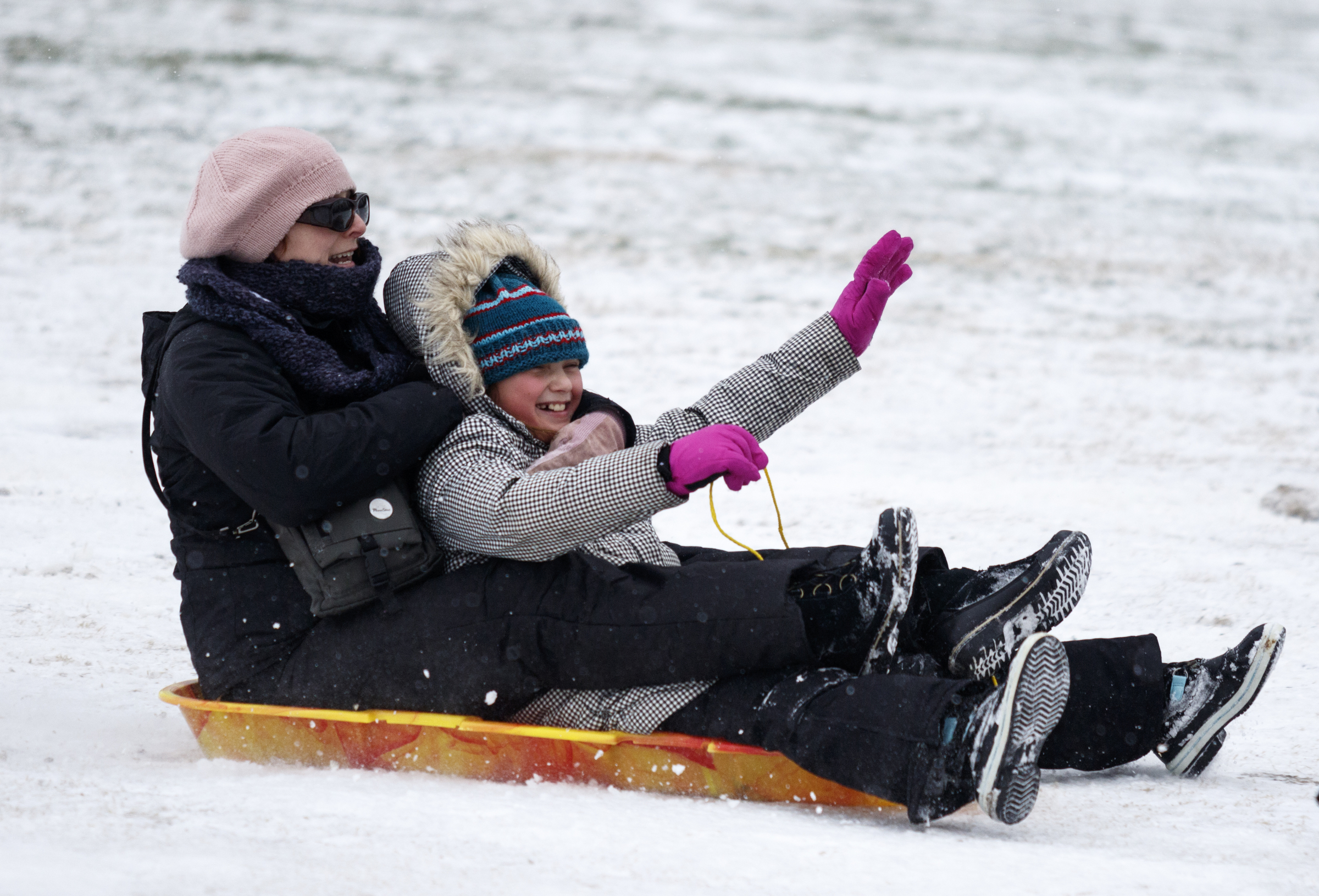 Caroline Kaplan, left, and her daughter Amelia sled on a fairway of the Signal Mountain Golf and Country Club after winter storm Jonas swept across the Eastern United States on Saturday, January 23, 2016, in Signal Mountain, Tenn. While much of the East Coast received heavy snowfall, the Tennessee Valley was less effected.
