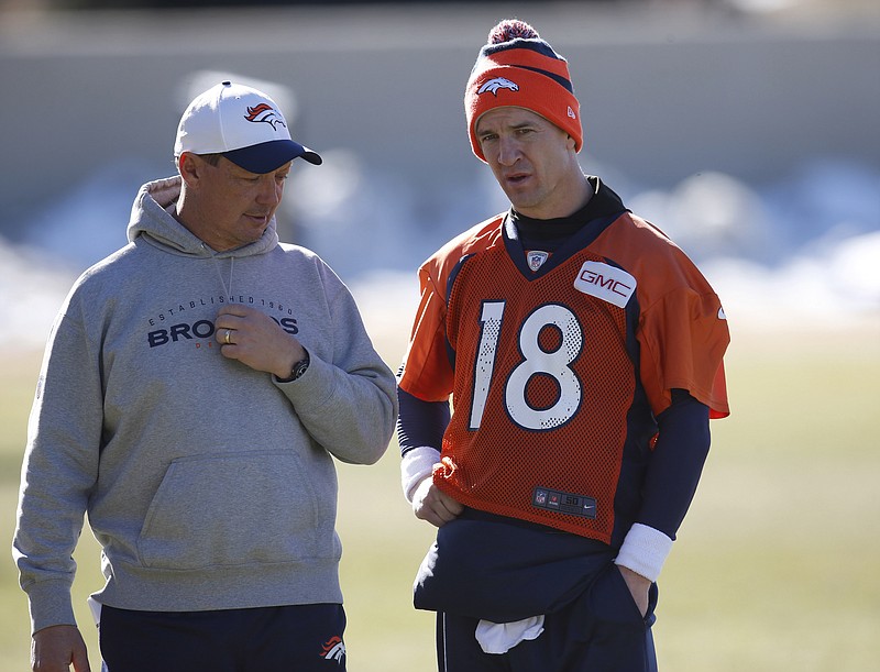 Denver Broncos offensive coordinator Rick Dennison, left, confers with quarterback Peyton Manning following the NFL football team's practice Friday, Jan. 22, 2016, in Englewood, Colo. The Broncos are scheduled to host the New England Patriots in the AFC championship game Sunday in Denver. (AP Photo/David Zalubowski)