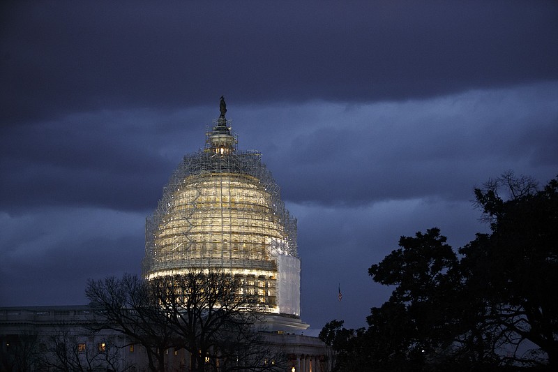 In this Dec. 1, 2014, file photo, the Capitol is seen at dusk in Washington. As the first 2016 presidential voting draws near, most Americans have little-to-no confidence in the federal government to confront what they see as its most important priorities in the next year, according to the results of a new national survey. The Associated Press-NORC Center for Public Affairs Research poll conducted in December found more than six out of 10 respondents expressing only slight confidence, or none at all, that the federal government can make progress on the problems facing the country in 2016.(AP Photo/J. Scott Applewhite, File)