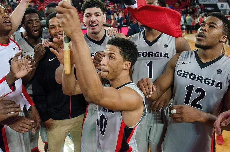 Georgia guard J.J. Frazier (30) leads the team in raising the flag after a 73-70 victory over Arkansas during an NCAA college basketball game Saturday, Jan. 23, 2016, in Athens, Ga. (Taylor Craig Sutton/Athens Banner-Herald via AP)