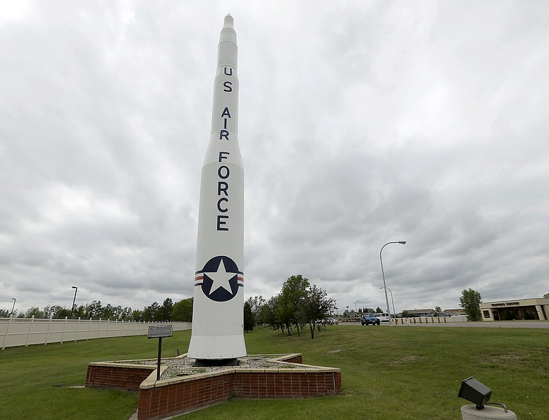  In this June 25, 2014, file photo, a retired Minuteman 1 missile stands at the main entrance to Minot Air Force Base, N.D. The Minuteman 1 was replaced by the Minuteman 3 by 1971 which now form the foundation of the US nuclear defense strategy. In the spring of 2014, as a team of experts was examining what ailed the U.S. nuclear force, the Air Force withheld from them the fact that it was simultaneously investigating damage to a nuclear-armed missile in its launch silo caused by three airmen. (AP Photo/Charlie Riedel)