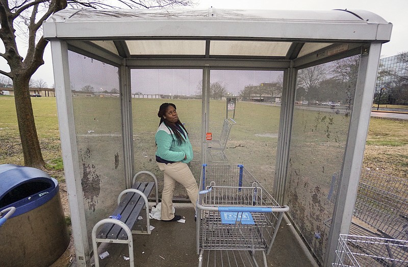 Staff Photo by Dan Henry / The Chattanooga Times Free Press- 1/22/16. Chiquita Martin waits for the bus to begin her journey home after finishing her workday at the Brainerd Wal-Mart on January 22, 2015. Martin says it takes an average of two hours each way and a number of line changes to commute from her Alton Park residence to work using CARTA's bus system. 