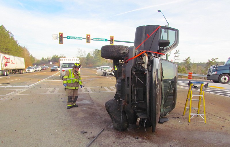 A black 2015 GMC Sierra truck is on its side after a crash in Dalton this morning.