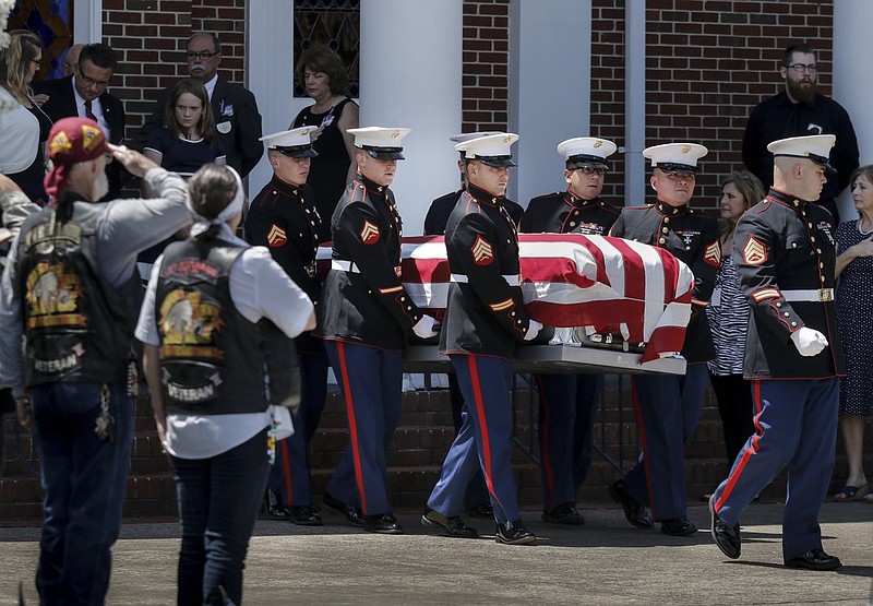Mourners salute as United States Marines carry the casket of U.S. Marine Corps Staff Sgt. David Wyatt out of Hixson United Methodist Church after his funeral service Friday, July 24, 2015, in Hixson, Tenn. Staff Sgt. Wyatt was killed in the July, 16 shootings at the Naval Operational Support Center and Marine Corps Reserve Center on Amnicola Highway which left five dead, including shooter Mohammad Youssef Abdulazeez, and a Chattanooga police officer wounded.
