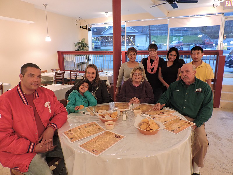 Front from left, Rossville residents/family members Brian Durbin, Aaliyah Hill, Ashley Hill, Libby Goodman and Jesse Goodman Jr. dine at the new La Familia Mexican Restaurant. Back from left are chef/co-owner Carmen Guzman, waitress Ashley Franklin, co-owner/manager Paulina Martinez and first cook Delmar Morales. Franklin recommends that customers try the Philly cheesesteak, nachos or tacos.