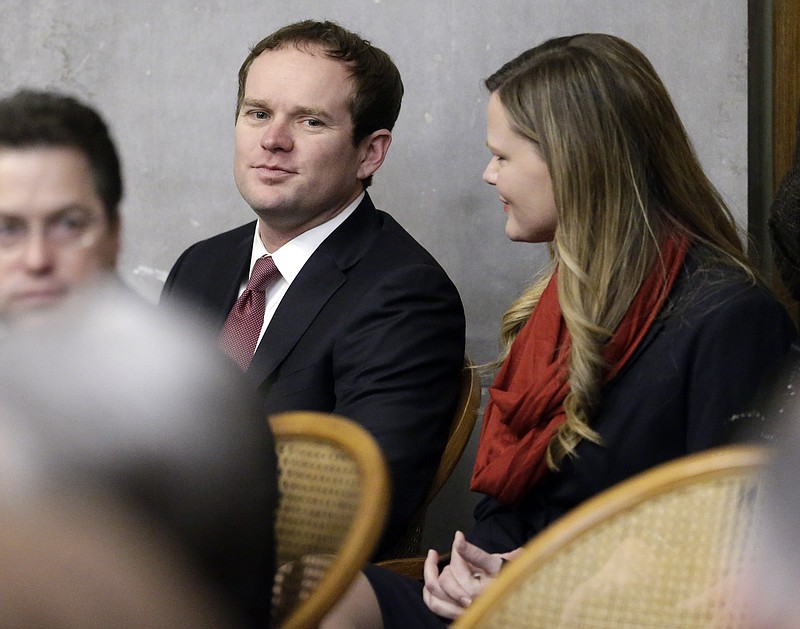 Rep. Jeremy Durham, R-Franklin, center, talks with his wife, Dr. Jessica Durham, before a House Republican caucus meeting on the opening day of the second session of the 109th General Assembly Tuesday, Jan. 12, 2016, in Nashville. Durham survived an effort to oust him from his leadership role among state House Republicans that day, but resigned as House Majority Whip over the weekend after three women said he sent them inappropriate texts. (AP Photo/Mark Humphrey)