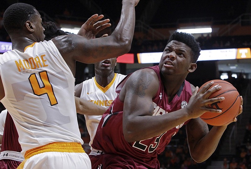 South Carolina forward Eric Cobb (23) looks to shoot as he's pressured by Tennessee forward Armani Moore (4) during the first half of an NCAA college basketball game Saturday, Jan. 23, 2016, in Knoxville, Tenn. (AP Photo/Wade Payne)