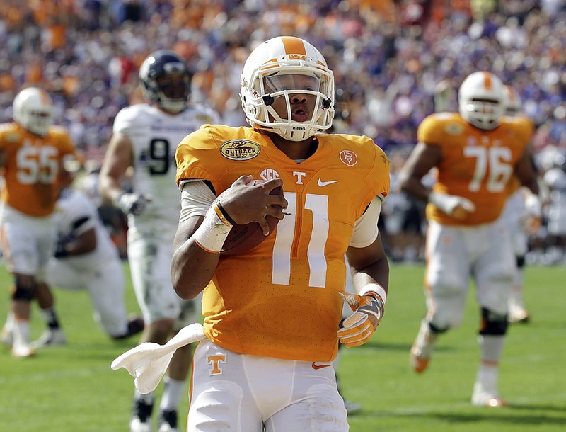 Tennessee quarterback Joshua Dobbs (11) runs 14-yards for a touchdown against Northwestern during the first quarter of the Outback Bowl NCAA college football game Friday, Jan. 1, 2016, in Tampa, Fla. (AP Photo/Chris O'Meara)