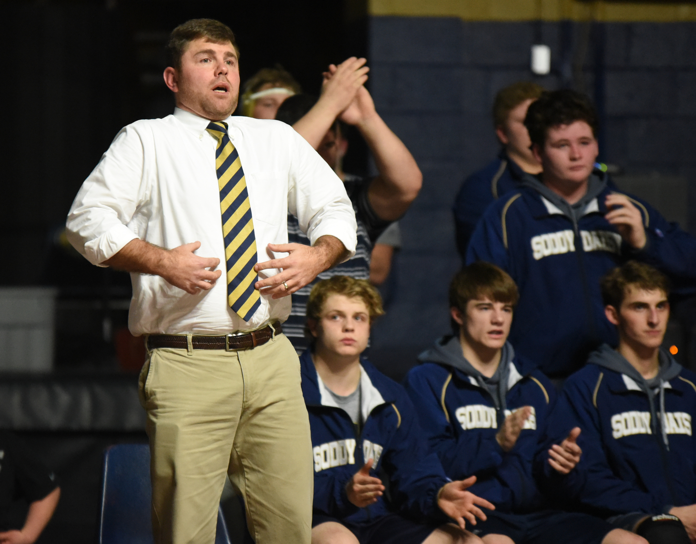 Soddy-Daisy coach Jim Higgins encourages his wrestler to breath from the bench Tuesday night at home against Bradley Central.