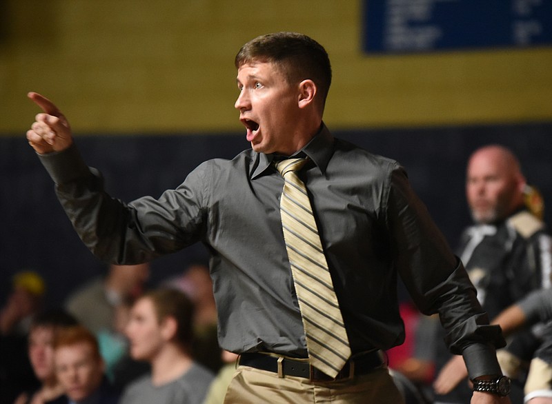 Bradley Central coach Ben Smith instructs his wrestler from the bench in a match at Soddy-Daisy.