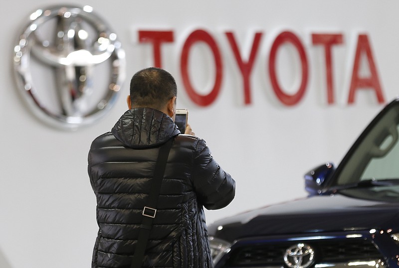 
              A visitor takes a photo at a Toyota showroom in Tokyo, Wednesday, Jan. 27, 2016. Toyota Motor Corp. says it sold 10.151 million vehicles in 2015, retaining its status as the world’s top-selling automaker for the fourth straight year. (AP Photo/Shizuo Kambayashi)
            