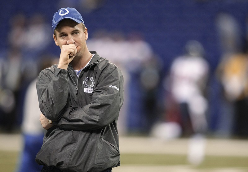 In this Dec. 22, 2011, file photo, Indianapolis Colts quarterback Peyton Manning stands on the field before the team's NFL football game against the Houston Texans in Indianapolis.