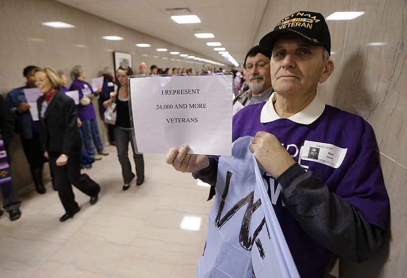 Gary Brown, right, of Knoxville, Tenn., demonstrates for the passage of Gov. Bill Haslam's Insure Tennessee proposal as lawmakers who defeated the measure last year return for the first day of the second session of the 109th General Assembly on Tuesday, Jan. 12, 2016, in Nashville