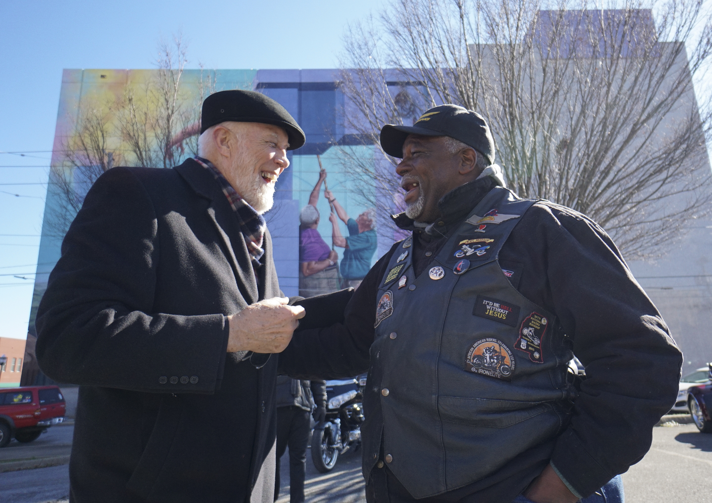 Franklin McCallie, left, congratulates Charlie Brown on his appearance in the mural directly behind them during the dedication of the M.L. King Boulevard mural project.
