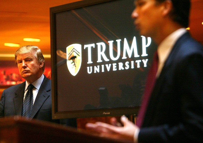 
              FILE - In this May 23, 2005 file photo, Donald Trump, left, listens as Michael Sexton, president and co-founder of the business education company, introduces him to announce the establishment of Trump University at a press conference in New York.  Long before Trump’s seductive mix of optimism and hyperbole proved a success on the campaign trail, it exerted a powerful tug on middle class folks involved in three companies he promoted as way for them to build wealth.  (AP Photo/Bebeto Matthews)
            