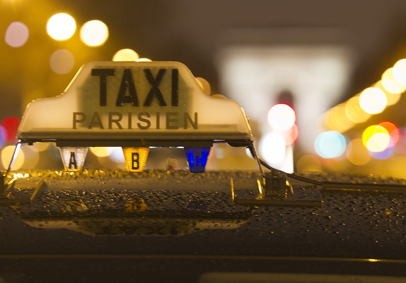 
              Taxis park during a protest in front of Arch de Triomphe in downtown Paris, early Wednesday, Jan. 27, 2016. Paris taxi drivers have resumed a strike protesting against rival services such as Uber, and city authorities are warning of roadblocks and traffic disruptions. (AP Photo/Jacques Brinon)
            