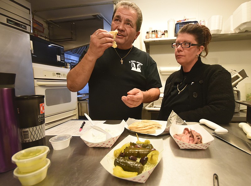 Paco and Maria Fotiadis discuss menu items inside the kitchen at Two Crazy Greeks, a take-out restaurant on Hixson Pike, near Highway 153.