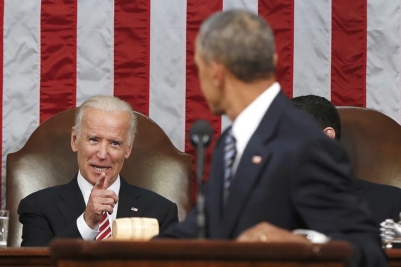 
              FILE - In this Jan. 12, 2016 file-pool photo, Vice President Joe Biden points at President Barack Obama during the president's State of the Union address to a joint session of Congress on Capitol Hill in Washington. President Barack Obama is creating a new federal task force to accelerate cancer research. He's tapping Biden to chair the effort. Obama signed a presidential memorandum Thursday, Jan. 28, 2016, establishing the White House Cancer Moonshot Task Force. (AP Photo/Evan Vucci, Pool, File)
            