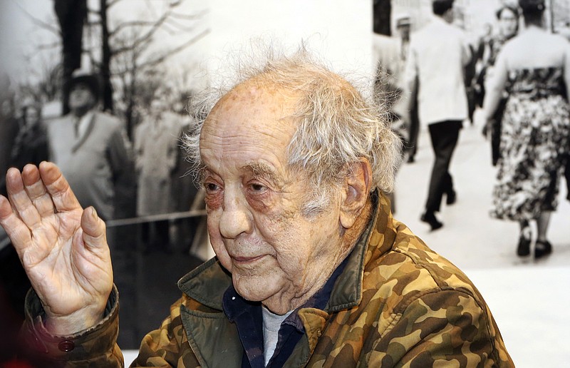 
              Photographer and filmmaker Robert Frank waves to a packed audience at the opening of the exhibition featuring his work, "Robert Frank: Books and Films, 1947–2016," at New York University's Tisch School of the Arts on Thursday, Jan. 28, 2016, in New York. The exhibit is not considered a retrospective, but focuses instead on Frank's output as a book-creator and filmmaker. (AP Photo/Kathy Willens)
            