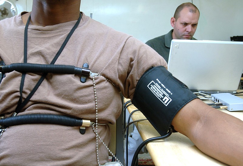 U.S. Air Force Staff Sgt. Jason Arnold, 407th Expeditionary Communications Squadron, acts as an examinee for an Office of Special Investigations polygraph examiner during Operation Iraqi Freedom at Ali Base, Iraq, March 4, 2006. (Staff Sgt. Valerie Smith/U.S. Air Force/MCT) 