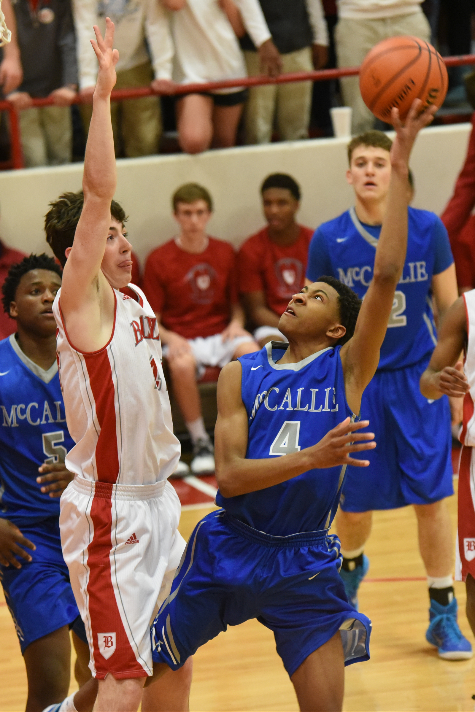 McCallie's Jr. Clay (4) shoots an off balanced shot as Baylor's Patrick Ureg defends Friday night in first half action at Baylor.