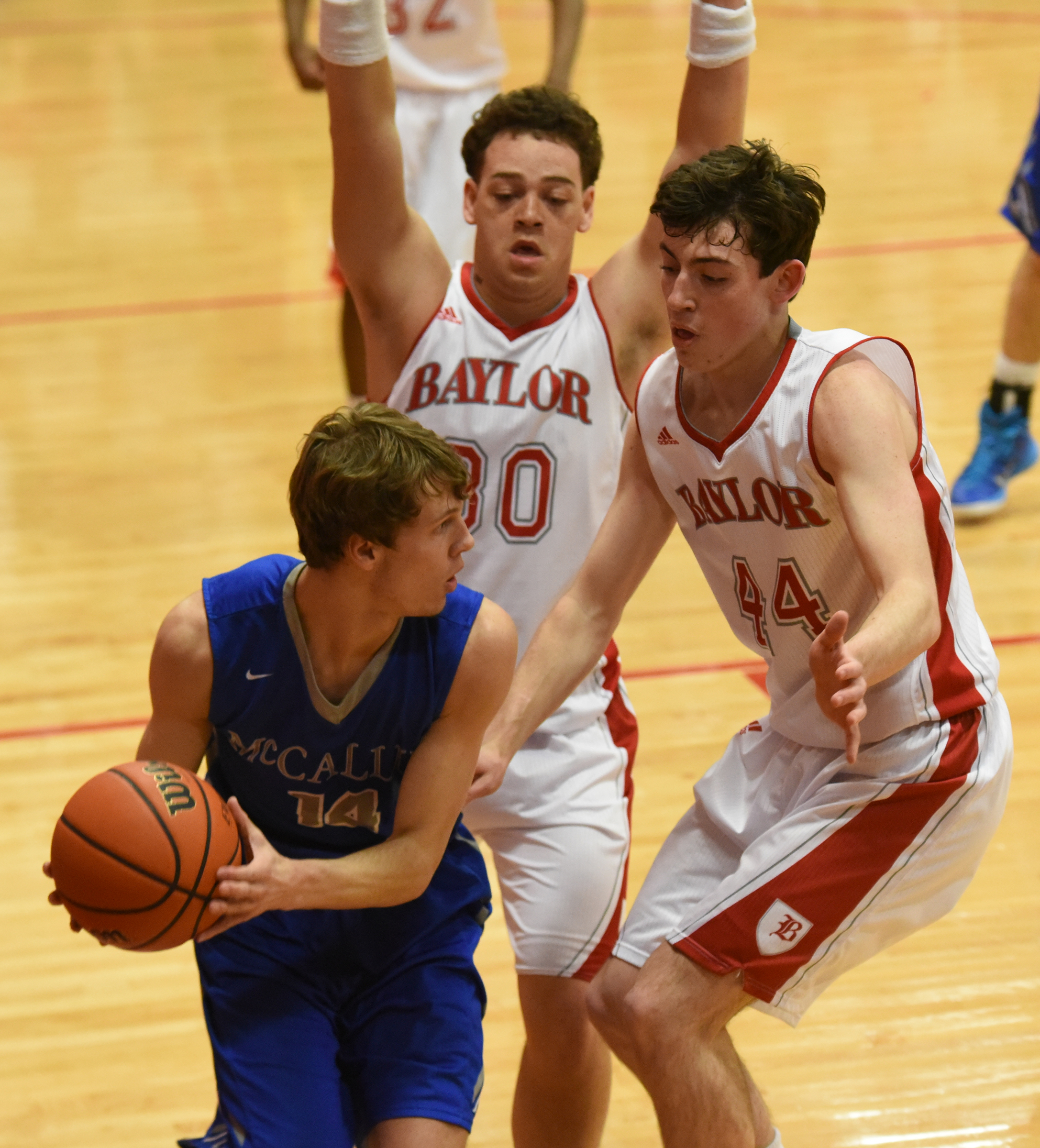 McCallie's Seth Clark (14) is covered by Baylor's Gage Upshaw (30) andPatrick Ureg (44) in a close first half at Baylor Friday night.
