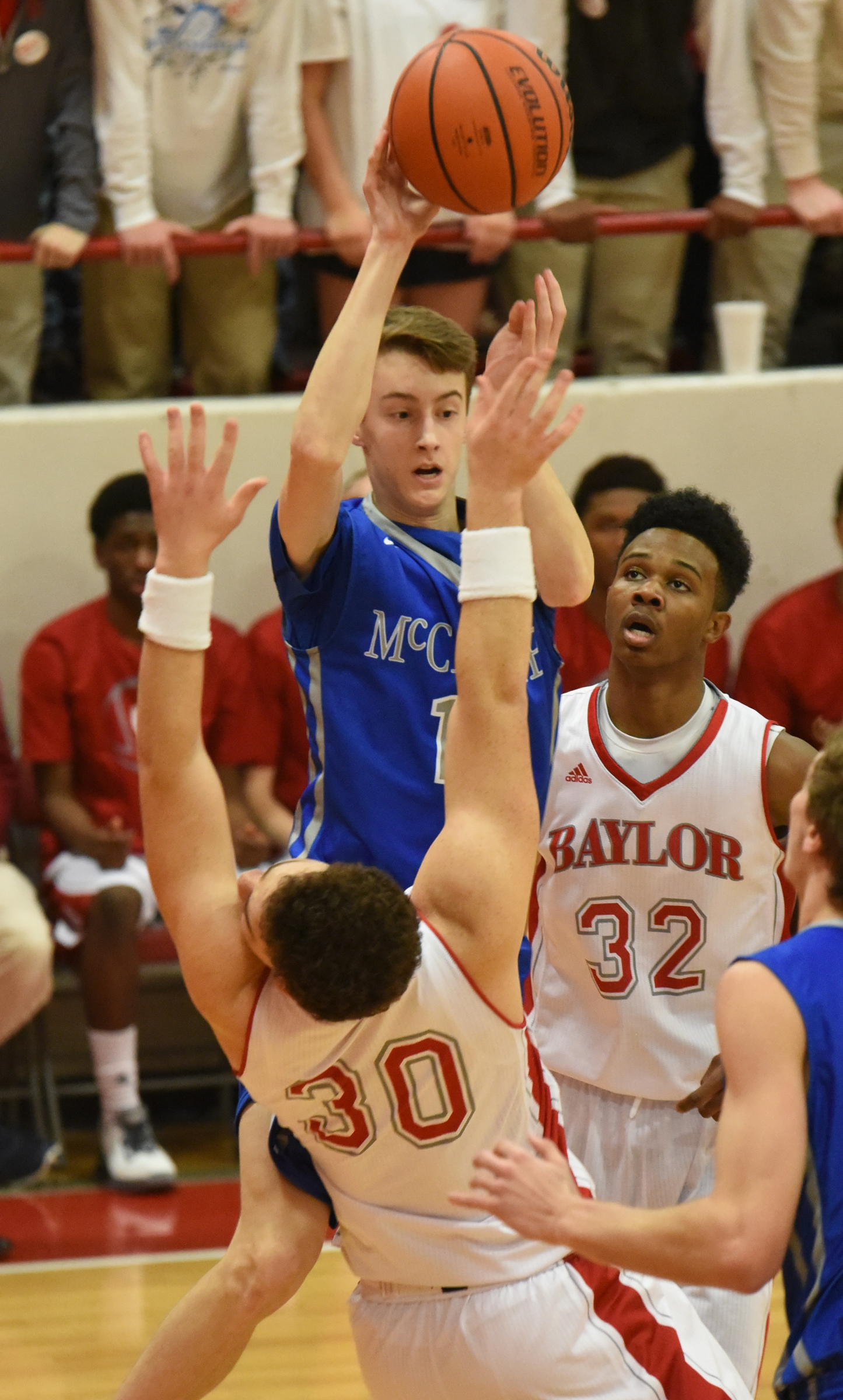 Baylor's Gage Upshaw (30) takes the hit below from McCallie's Henley Edge, top, as Baylor's Jaylon Baker (32) watches the possible charge develop in first half action.