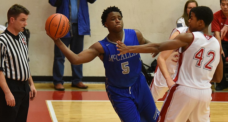 McCallie's Adrian Thomas (5) looks to pass inside around Baylor's Niko Simpkins (42) in first half action.