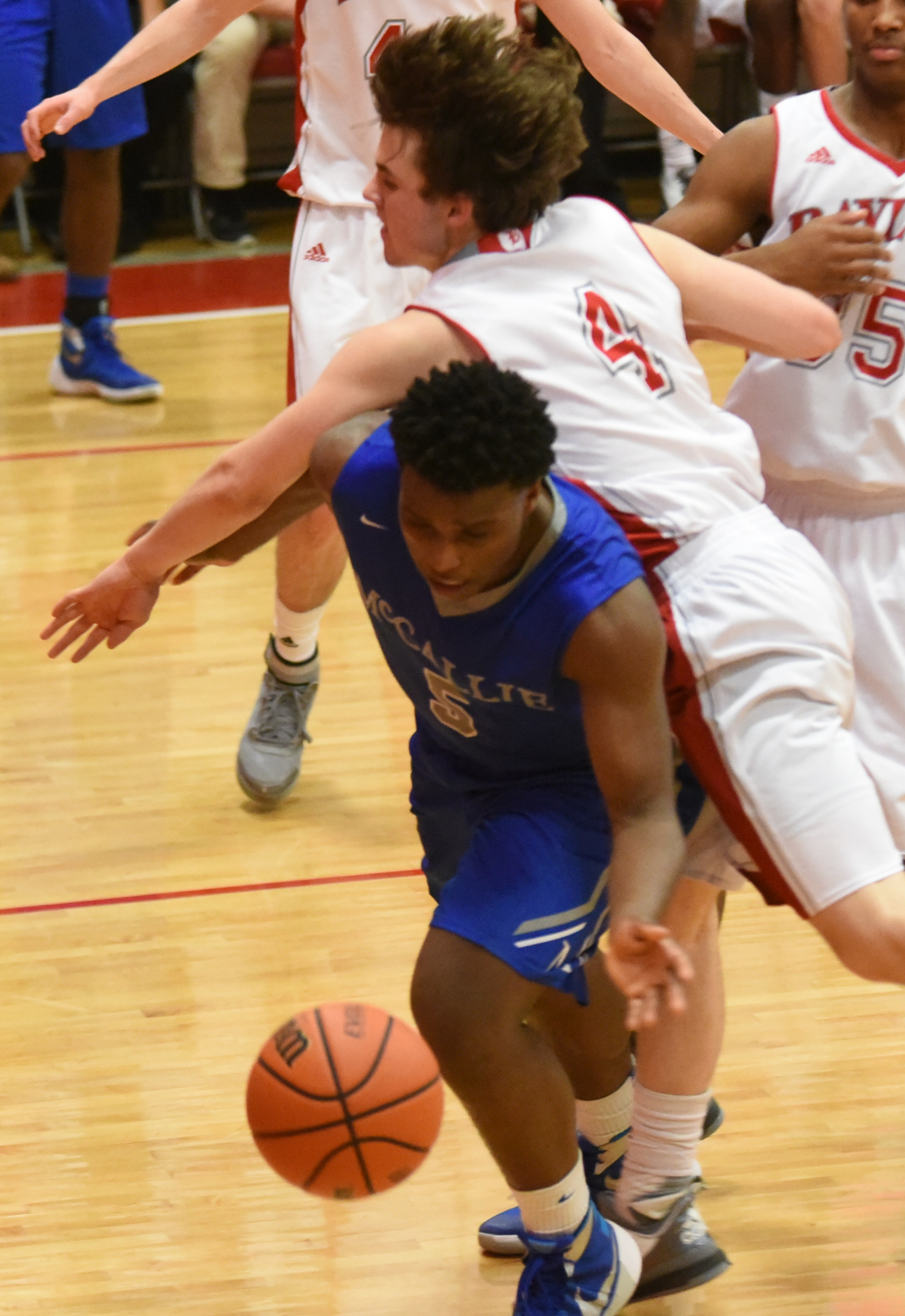 Baylor's Will Snead (4) goes over the back of McCallie's Adrian Thomas (5) on a loose ball Friday night at Baylor.