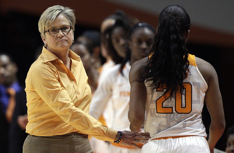 Tennessee head coach Holly Warlick pats guard Te'a Cooper (20) as she leaves the game in the second half of an NCAA college basketball game against the Virginia Tech Sunday, Dec. 6, 2015, in Knoxville, Tenn. Virginia Tech won 57-43. (AP Photo/Wade Payne)