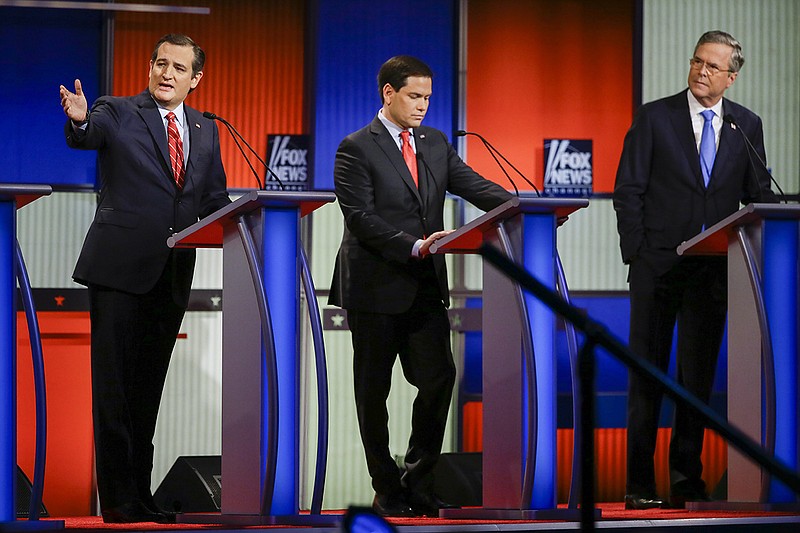 Republican presidential candidate Sen. Ted Cruz, R-Texas, left, answers a question as Sen. Marco Rubio, R-Fla., center, listens and former Florida Gov. Jeb Bush, right, looks on during a Republican presidential primary debate, Thursday, Jan. 28, 2016, in Des Moines, Iowa. (AP Photo/Charlie Neibergall)