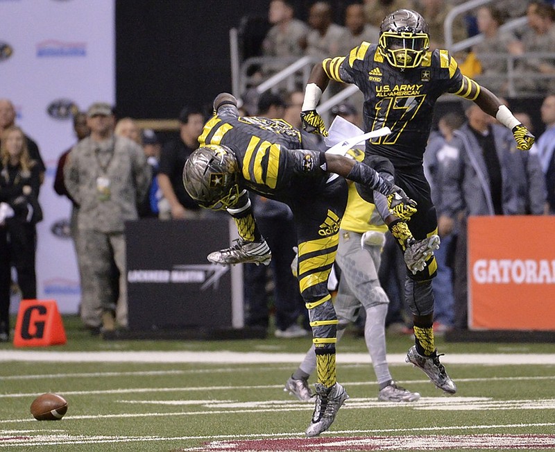 Tyler Byrd (17), shown celebrating with a teammate after intercepting a pass during the first half of last month's U.S. Army All-American Bowl, is among the football recruits Tennessee hopes to land on national signing day. Byrd has made a non-binding commitment to Miami but could change his mind before Wednesday.