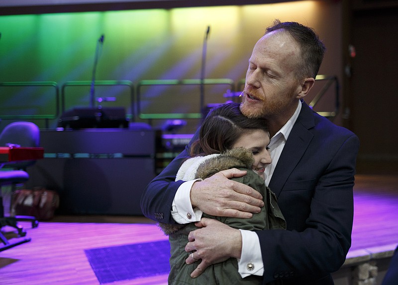 Protectors founder Paul Coughlin, right, hugs Melody Hutson after seeing her again on the first day of the Courageous Community Conference at Silverdale Baptist Church on Sunday, Jan. 31, 2016, in Chattanooga, Tenn. Coughlin first met Hutson, now a homeschooled 10th grader, after she stood up against a bully on the playground when she was a 5th grader at SBA.