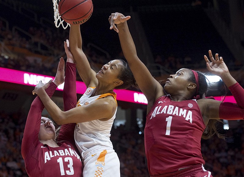 Tennessee's Jaime Nared is pressured by Alabama's Nikki Hegstetter, left, and Quanetria Bolton during an NCAA college basketball game in Knoxville, Tenn., Sunday, Jan. 31, 2016. Tennessee beat Alabama, 70-42. (Saul Young/Knoxville News Sentinel via AP) MANDATORY CREDIT