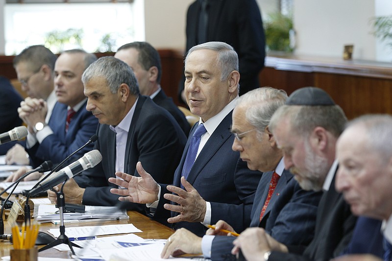 Israel's Prime Minister Benjamin Netanyahu, center, speaks during the weekly cabinet meeting in Jerusalem, Sunday, Jan. 31, 2016. (Amir Cohen/Pool Photo via AP)