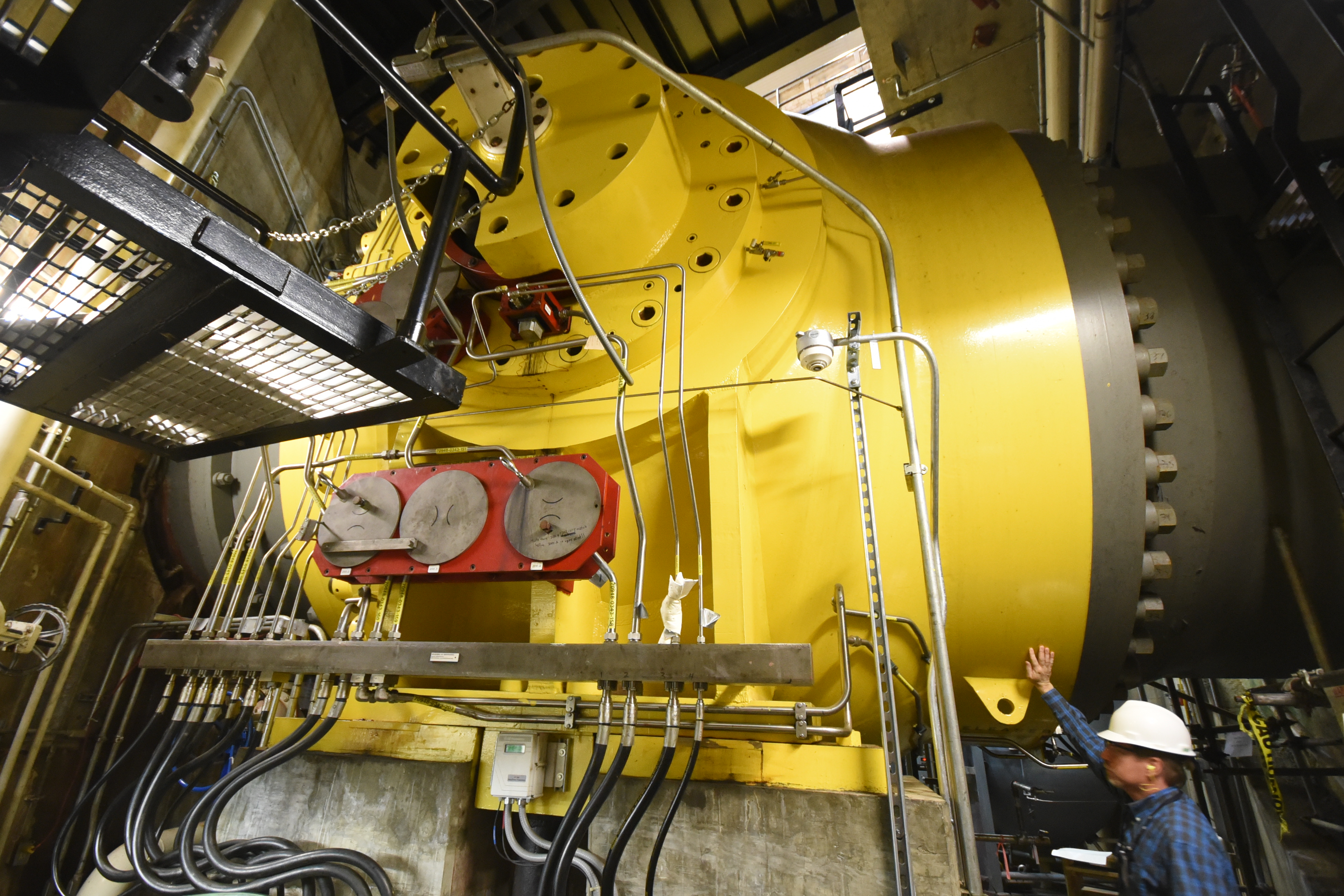 TVA spokesman Scott Fiedler stands below the giant ball valve that lets water drain from the reservoir to power the four hydroelectric generators at TVA's Raccoon Mountain Pumped Storage Plant.