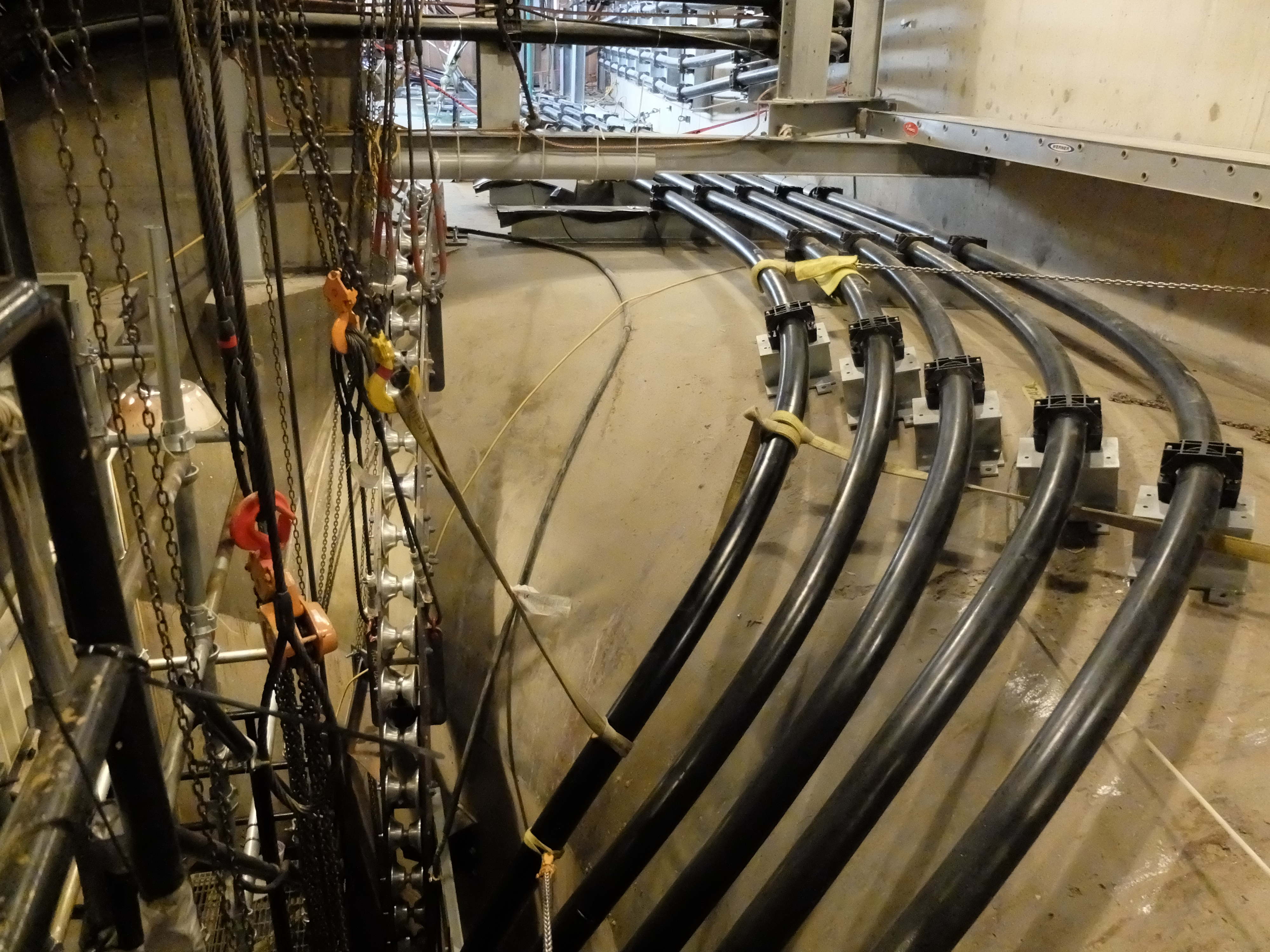 TVA recently replaced 15 giant cables that carry electricity from transformers that deep underground inside Raccoon Mountain to the power grid. The old cables had oil that ran through their center to cool them, which TVA worried might cause a fire someday. The new cables aren't oil-cooled, because they're larger and can handle more voltage. Each new cable is between 2,200 and 2,400 feet long and weighs about 15 pounds a foot. The cables were pulled by a winch up a cable shaft that doubles as the facility's elevator shaft. Tourists used to be able to ride the elevator, but it closed as a security measure after the Sept. 11, 2001, terrorist attacks.