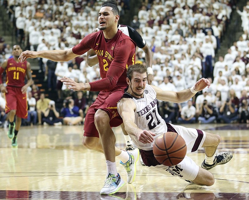 Texas A&M's Alex Caruso (21) fights for a loose ball against Iowa State's Abdel Nader (2) during the second half of an NCAA college basketball game, Saturday, Jan. 30, 2016, in College Station, Texas. Texas A&M won 72-62. (AP Photo/Sam Craft)