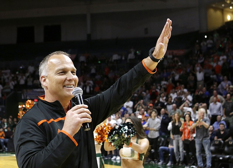 University of Miami football coach Mark Richt waves to the fans after being introduced during an NCAA basketball game between Miami and Florida, Tuesday, Dec. 8, 2015, in Coral Gables, Fla. (AP Photo/Alan Diaz)