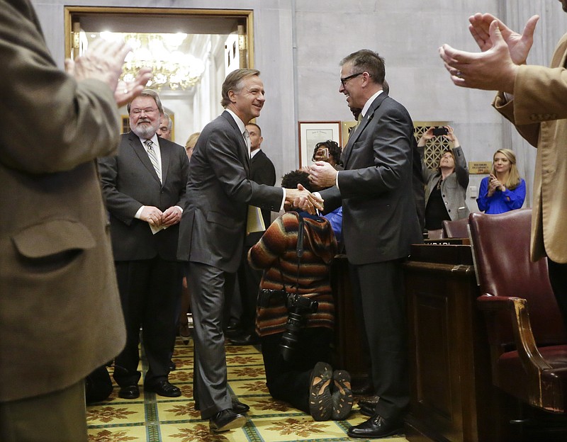 Tennessee Gov. Bill Haslam, center, is greeted as he enters the House chamber to deliver his State of the State Address on Monday in Nashville.