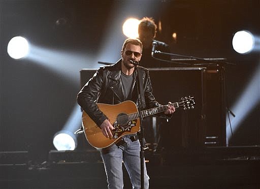 In this Nov. 4, 2015, file photo, Eric Church performs at the 49th annual CMA Awards at the Bridgestone Arena in Nashville, Tenn. Church and Chris Stapleton lead the early nominees for the 51st annual Academy of Country Music Awards with three nominations each, including male vocalist and album of the year. ACM Awards co-host Dierks Bentley announced the nominees Monday, Feb. 1, 2016, for six categories. (Photo by Chris Pizzello/Invision/AP, File)