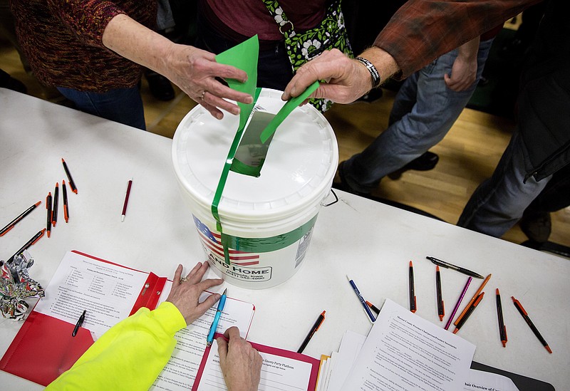 Caucus-goers cast their ballots at Pella High School in Pella, Iowa, on Monday. Next up, New Hampshire.