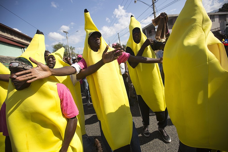 
              Haitians dressed as bananas to show their support for organic banana farmer and presidential candidate Jovenel Moise, from the PHTK party, march to demand elections be reinstated, in Port-au-Prince, Haiti, Tuesday, Feb. 2, 2016. Haiti had been scheduled to hold a presidential and legislative runoff Jan. 24. But the now-splintered provisional electoral council canceled it for a second time amid the protests and suspicion that the first round was marred by widespread fraud favoring Moise, President Michel Martelly's chosen candidate. (AP Photo/Dieu Nalio Chery)
            