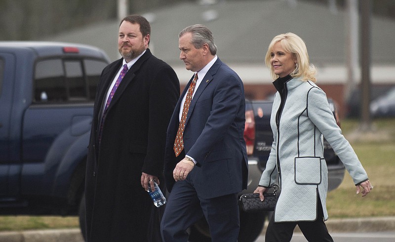Lance Bell, left, newly announced lead lawyer for Mike Hubbard, walks with Mike Hubbard and his wife Susan Hubbard as they leave the Lee County Justice Center after a hearing on Friday, Jan. 8, 2016, in Opelika, Ala. Lee County Circuit Judge Jacob Walker handed down a gag order to prevent lawyers from speaking to the media in the ethics case against indicted Alabama House Speaker Mike Hubbard.