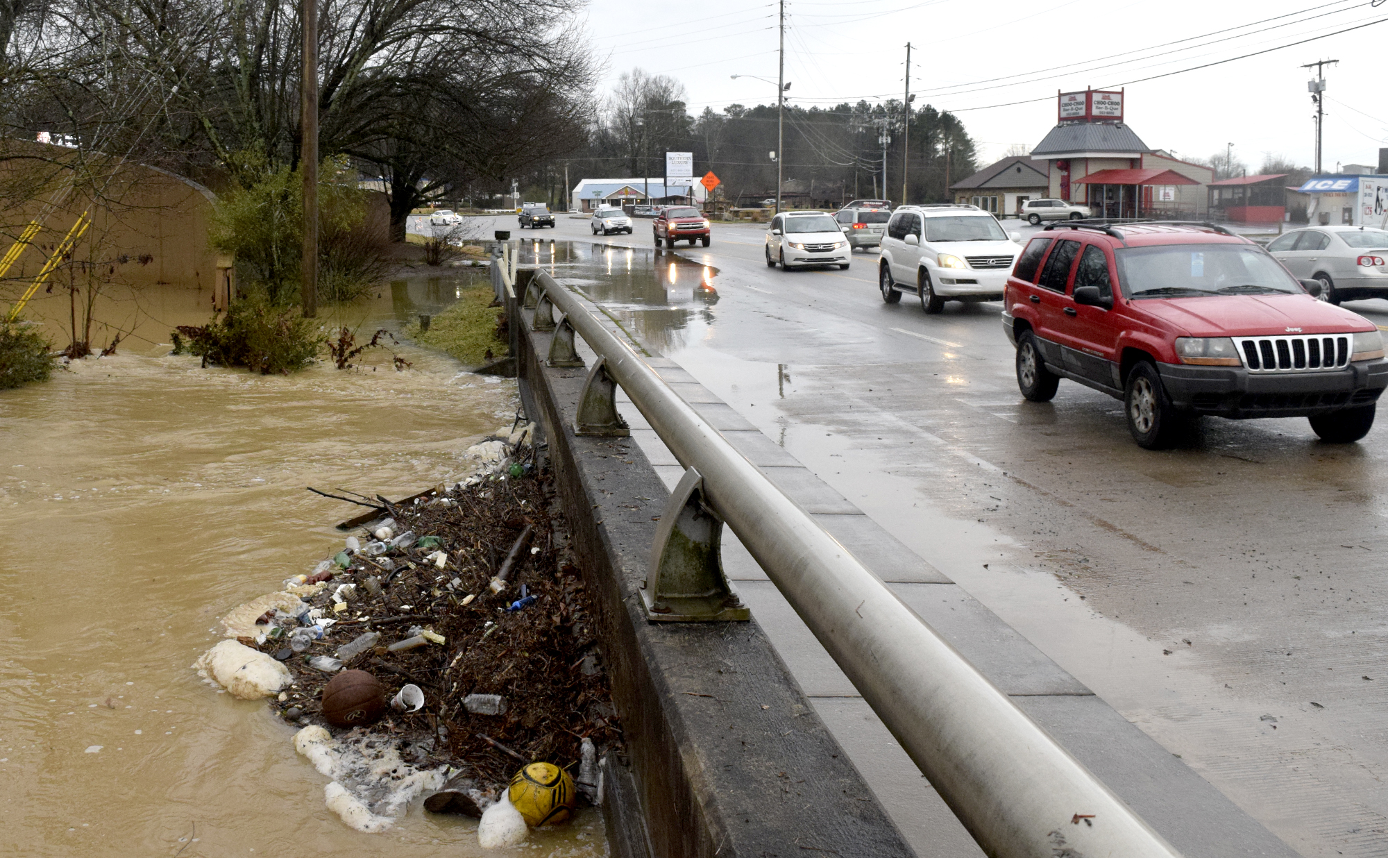 Debris is piled against the East Brainerd Road bridge over Mackey Branch as traffic avoids the flooded eastbound lanes.  For a while the road was totally closed by flood waters.  Early morning flooding created traffic problems in the East Brainerd area on Wednesday February 3, 2016.